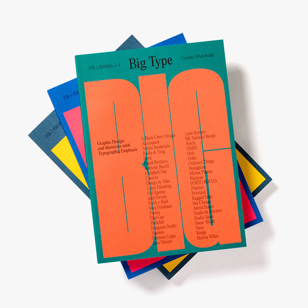 Three copies of Big Type fanned on top of each other, showing thr different colour covers in which the publication is published
