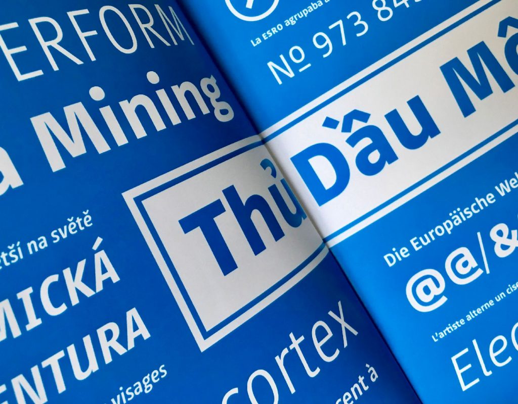 Example of printed typeface (in Polish) in a brochure on mid-blue coloured pages.