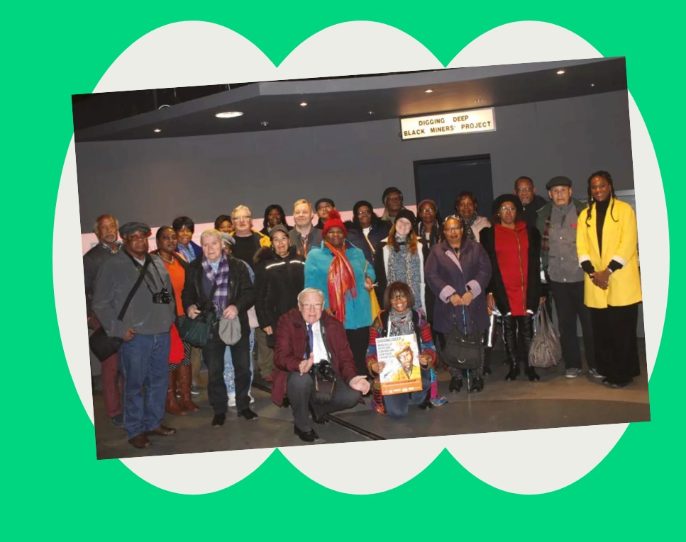 Photo of a culturally mixed group of older people inside smiling to camera.