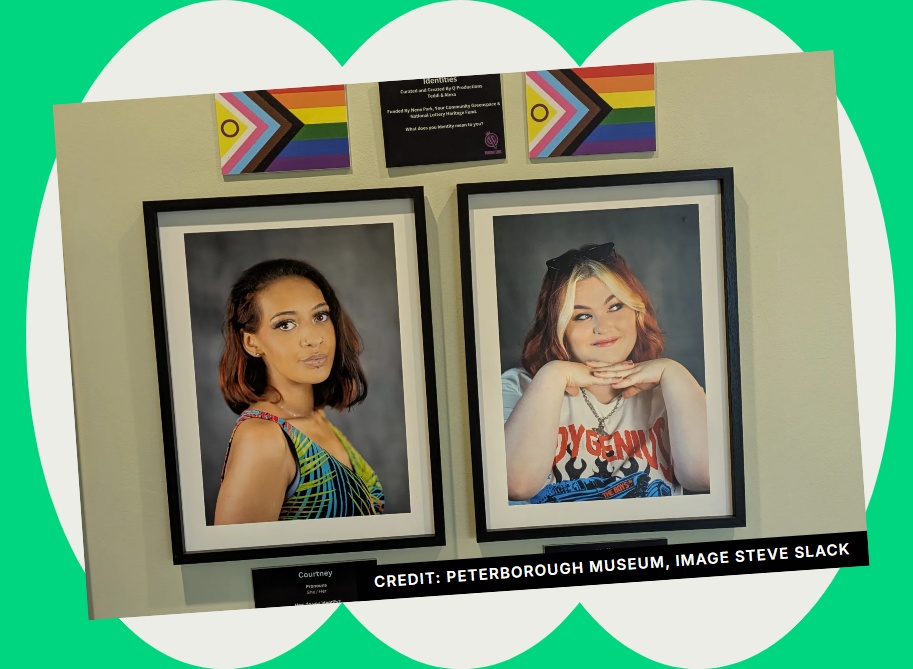 Two black framed head and shoulder photos of young women, beneath LBGTQIA+ flags