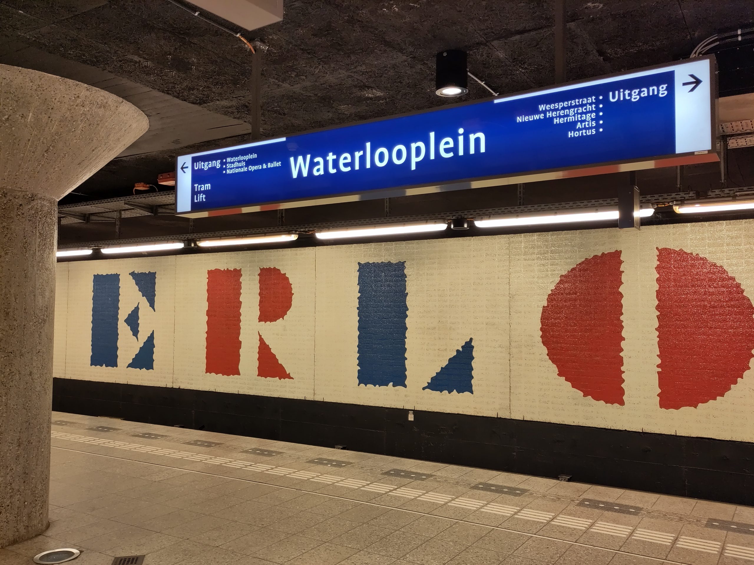 Signage for the Amsterdam Metro (the Netherlands) station, Waterlooplein above a white, red and blue tiled wall