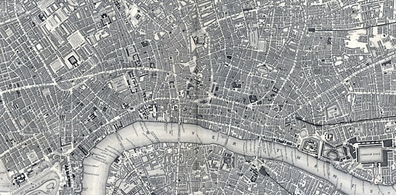 Excerpt from black and white map featuring urban developed area and river flowing through it