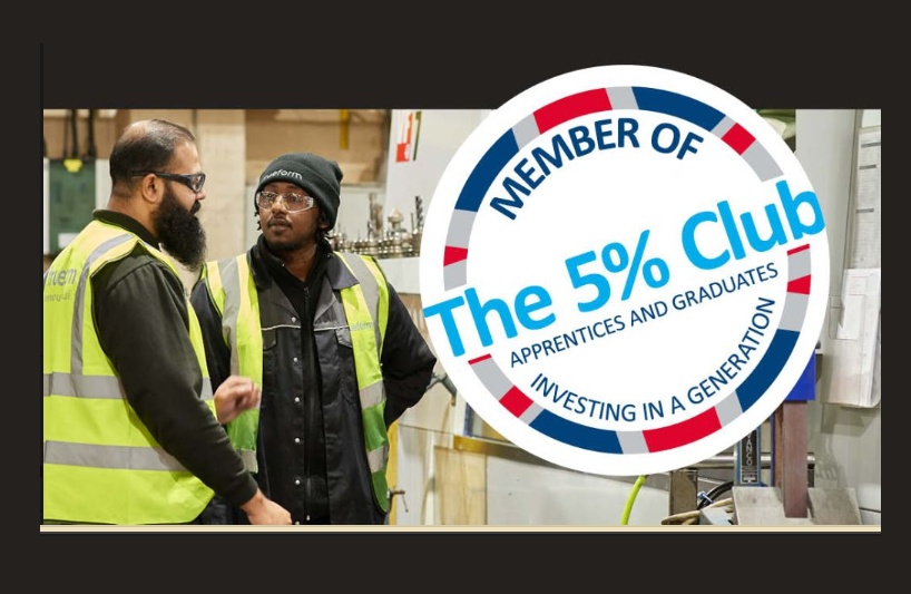 Trueform joins The 5% Club (a group of works in high viz jackets chatting to each other indoors