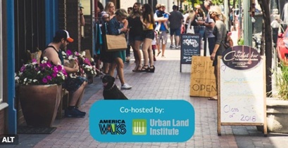 An American wide sidewalk on a summer day, showing people sitting down, standing around chillaxing