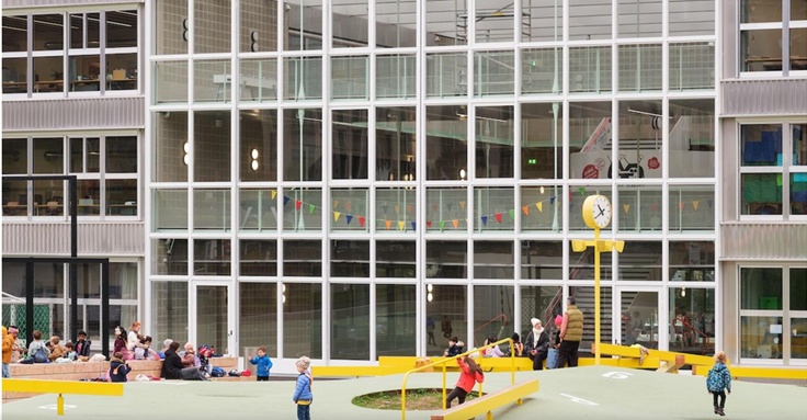 External view of the Barbican Centre building, showing people including young children outside (photo taken in autumn / winter).