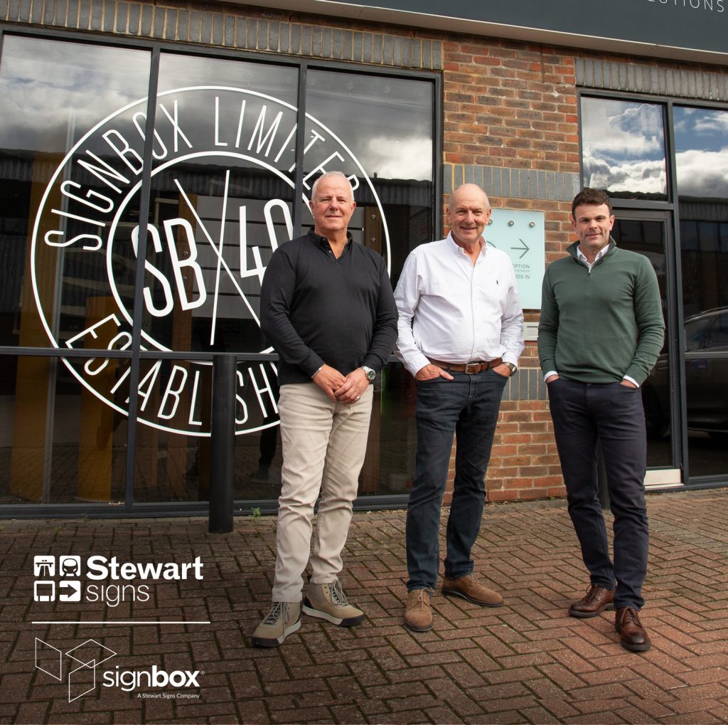 L-R in front of Signbox  building: Matt Wilkins (Signbox Director),  Mark Bartlett (Signbox Managing Director),  Gareth Livingstone Stewart Signs MD