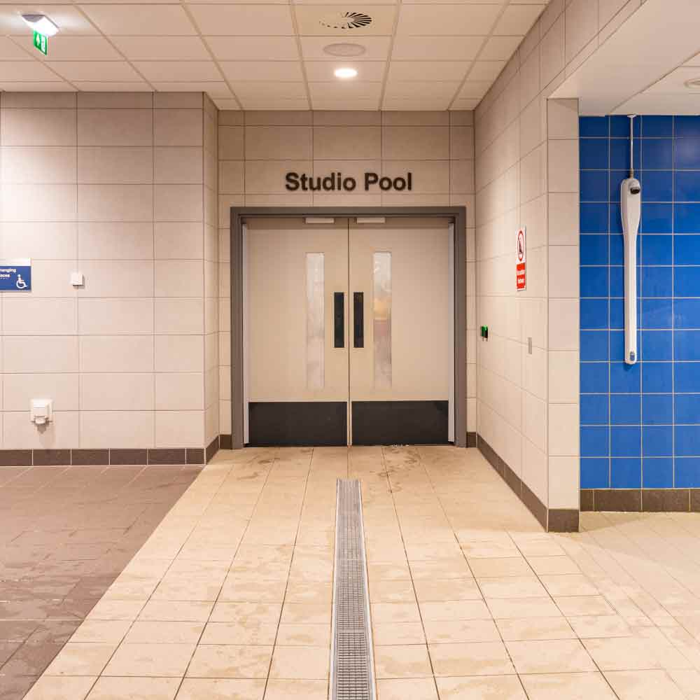 A view of interior signage for the studio pool at Sandwell Aquatics Centre, with signage by xsign