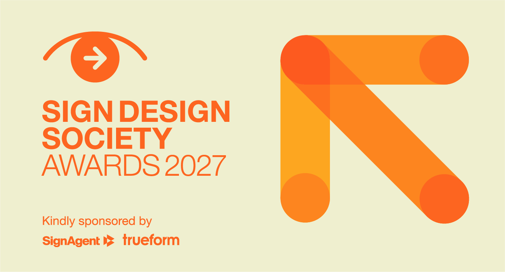 A bold orange geometric arrow shape sits on a cream background beside the title “Sign Design Society Awards 2027,” with sponsor logos for SignAgent and Trueform shown underneath.