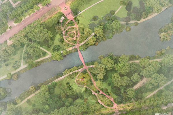 Aerial view of fields and trees on either side of a river, with a road running parallel in the background.